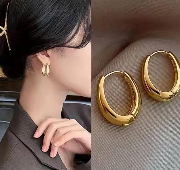 Gold plated oval hoop earrings showcased on a model, highlighting their bold and elegant design with a smooth, shiny finish.
